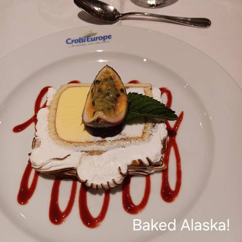 Dessert with passion fruit on a plate with garnished sauce.