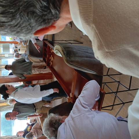 People gathered around a table looking at a board game.