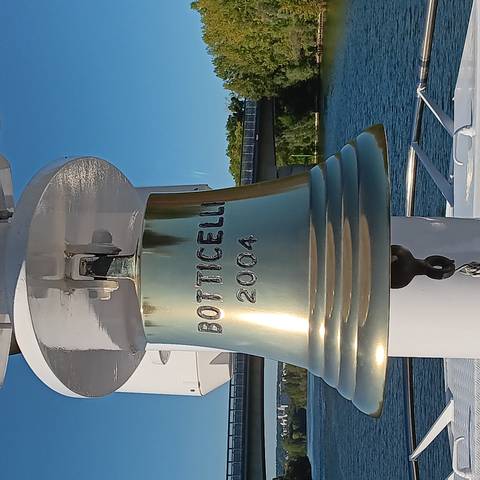 A ship's bell with engraved text.