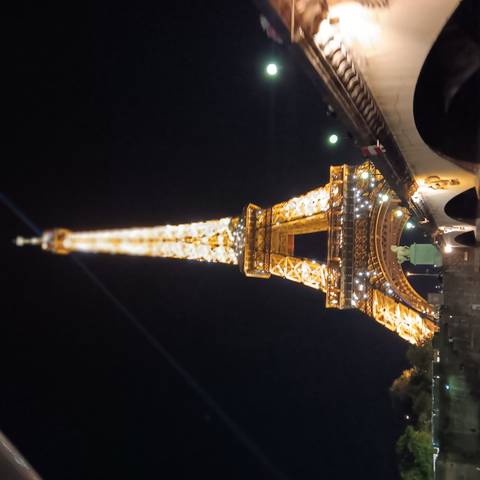 Illuminated Eiffel Tower at night.