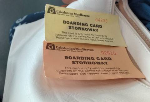Boarding cards for Stornoway ferries on a pink surface.