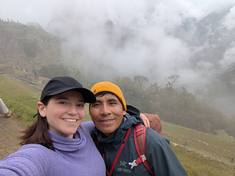 Selfie with a smiling person and guide at Machu Picchu.