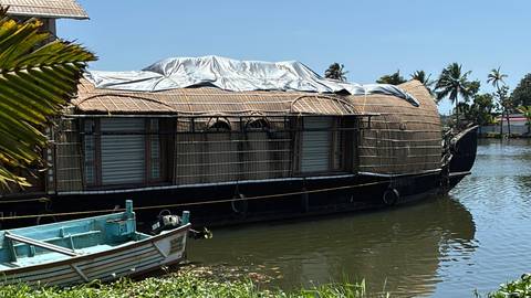 Traditional houseboat floating on a tranquil waterway.