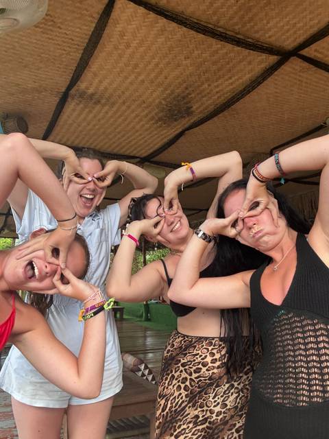 Group of people making funny faces inside a building.