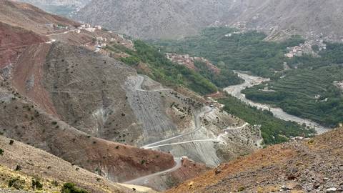 View over a mountainous landscape with winding roads.