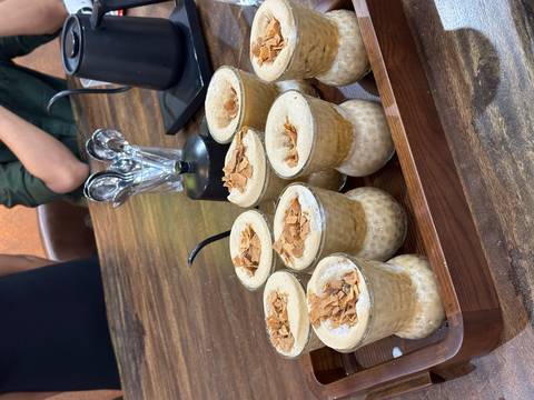 An enticing display of mugs filled with rich beverages and toppings on the table.