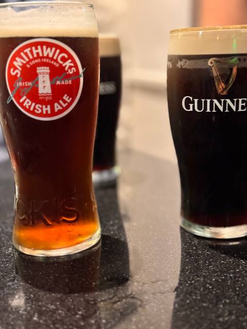 Two glasses of Irish ales, one being Guinness.
