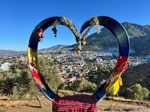View of a town through a heart-shaped art piece, Chefchaouen.