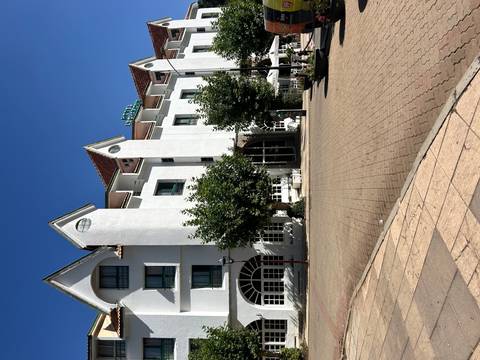 Building with trees and a large brick plaza, Ifrane.