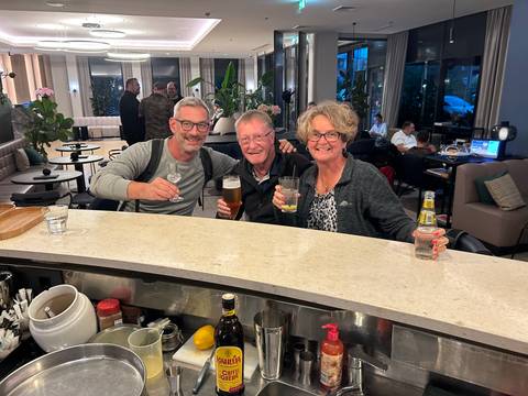 People enjoying drinks in a cozy bar setting.