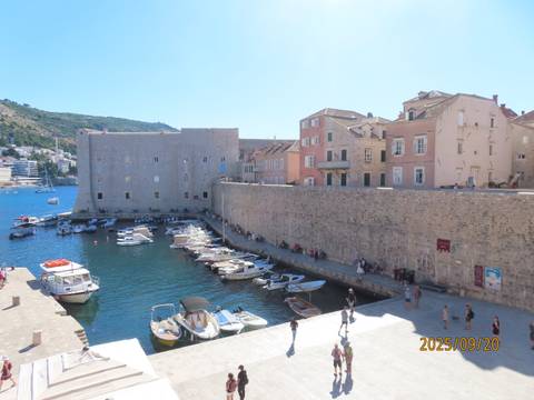 Boats docked by the historic city walls of Dubrovnik.