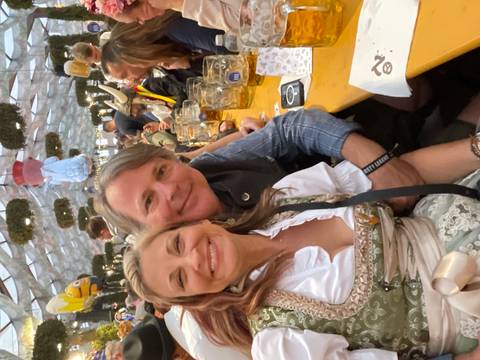 People enjoying a festival tent with drinks.