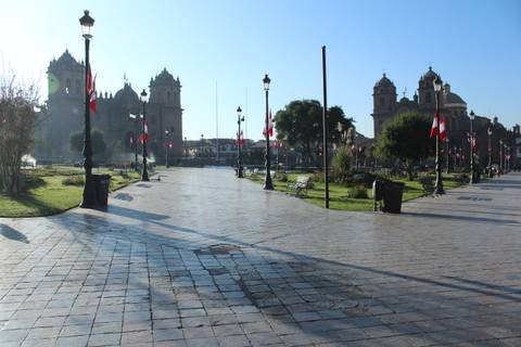City square with a church and Peruvian flags