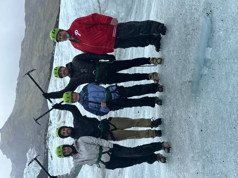 Group of people on a glacier hike with gear.