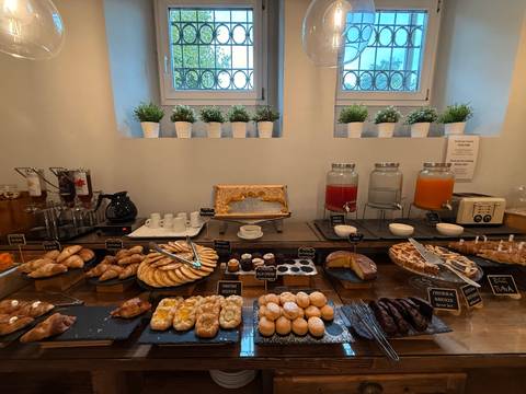 Buffet breakfast display with pastries and juices.
