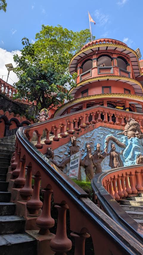 Temple with religious sculptures and a winding staircase.