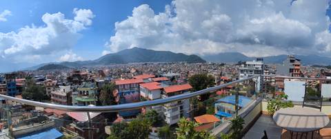 Panoramic view of a city surrounded by hills.