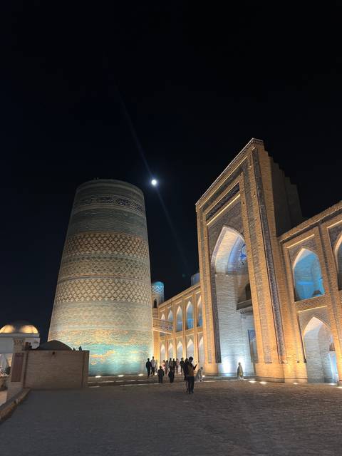 Moonlit view of distinctive blue-tiled structures.
