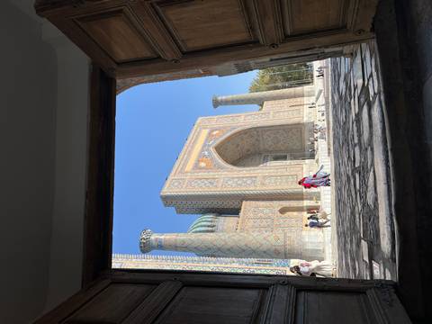Majestic entrance of Registan Square viewed from an archway.