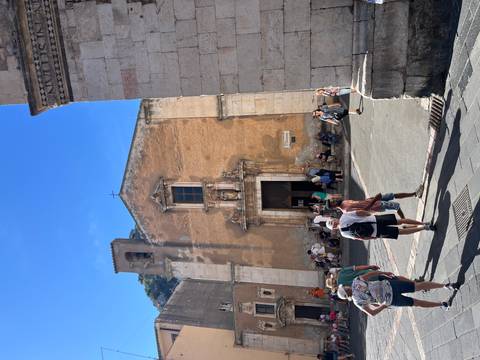 Tourists walking in front of a historical church.