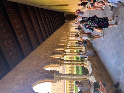 Tourists exploring historic cloisters.