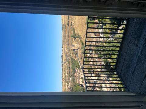 Balcony overlooking a rural landscape.