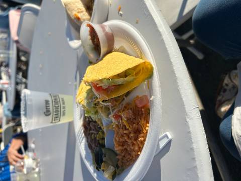 Plate with traditional Mexican food and a drink on a table.