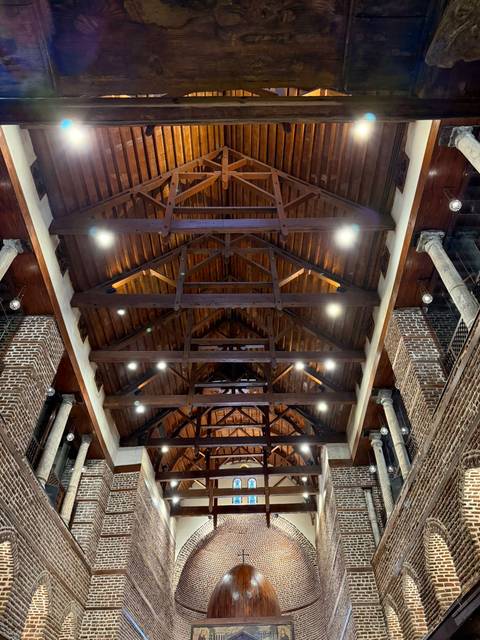 Architectural ceiling with wooden beams and lights.