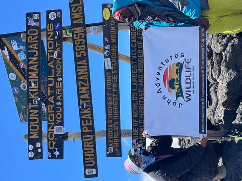 Summit signposts at Uhuru Peak, Mount Kilimanjaro.
