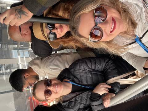 People taking a selfie inside a cable car or similar transport.