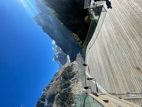 Scenic view of mountains and a glacier with a wooden platform.