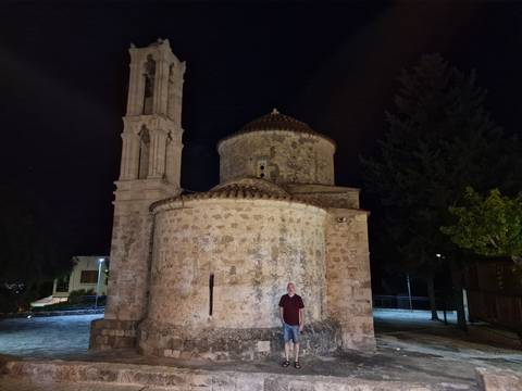 Old stone building at night with a person.