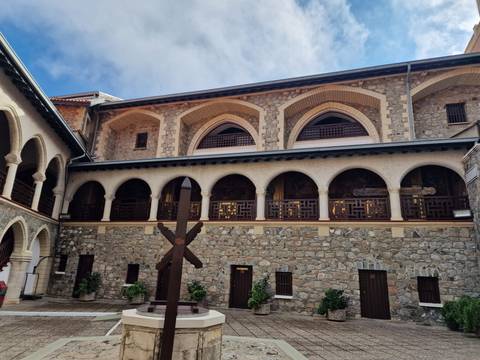 Courtyard of a stone building with arches.