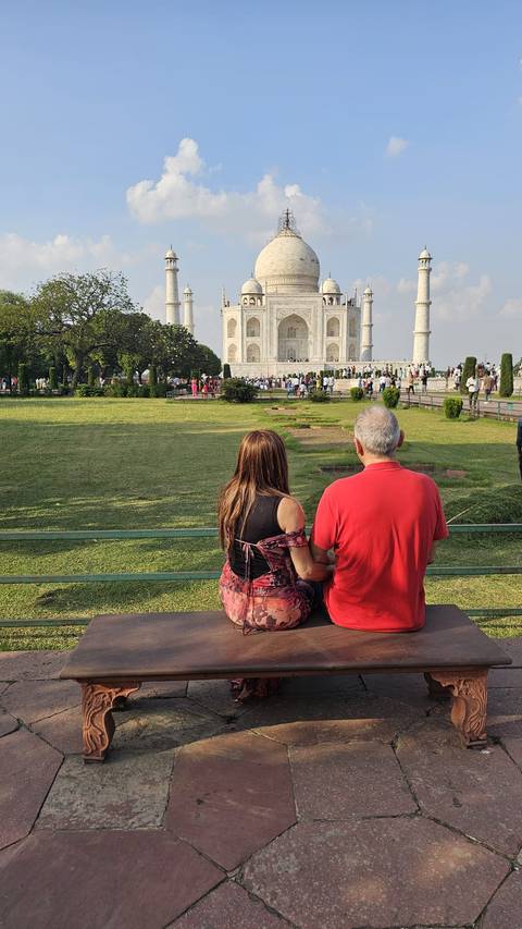 Tourists admiring the Taj Mahal from a distance.