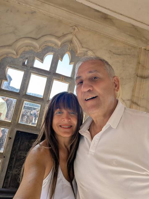 Close-up selfie of a couple inside a historical building.