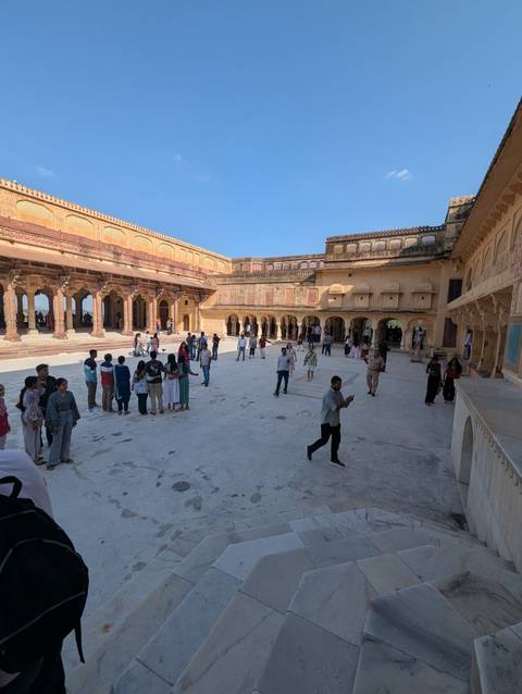 People gathered in a historic courtyard.