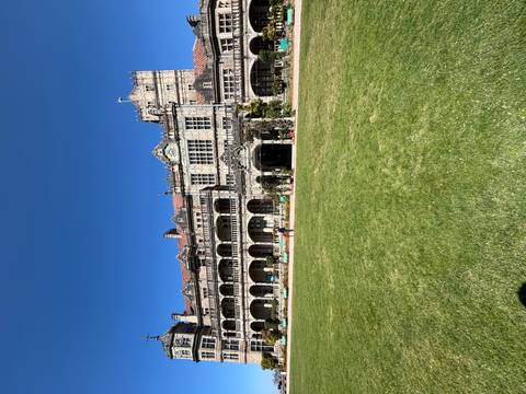 A heritage building with a lawn in front