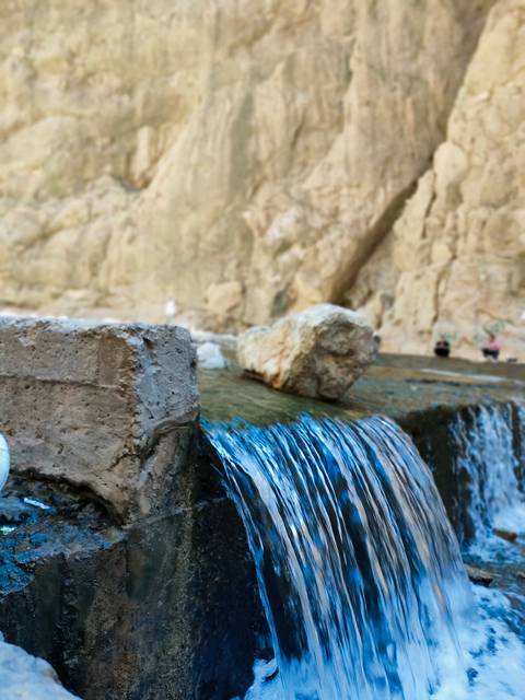 Blurry close-up of a waterfall with rocky background.