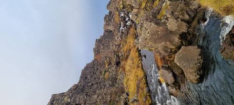 Rocky stream with moss-covered cliffs.