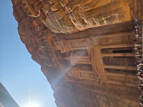 The Treasury in Petra with tourists gathered at the site.