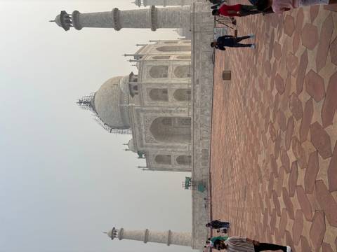 The Taj Mahal with scaffolding on a hazy day.