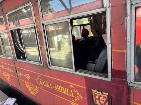 Close-up of a train compartment with signage visible.