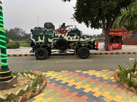 A heavily armored military vehicle on a paved road.