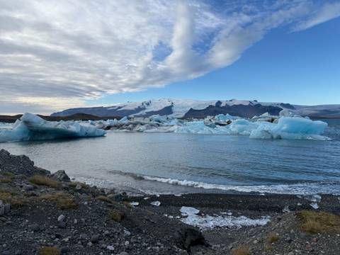 Scenic view of Jokulsarlon glacier lagoon with icebergs and mountains.