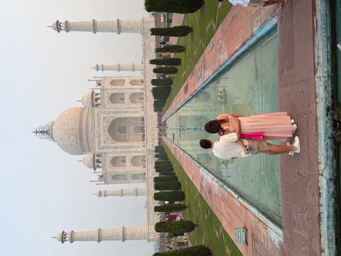 Couple admiring the Taj Mahal from a distance.