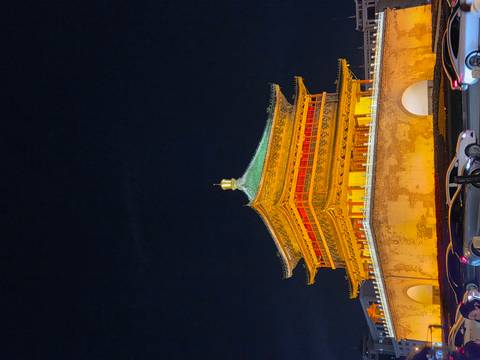 Illuminated traditional Chinese building at night.