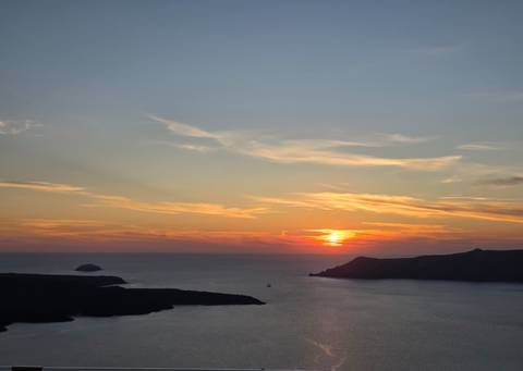 Sunset over the sea viewed from a cliff.