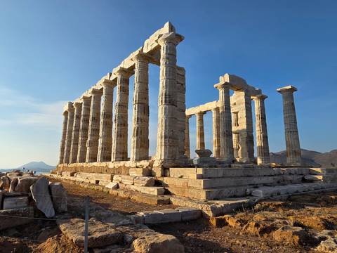 Ancient temple ruins with columns, sunny clear sky.