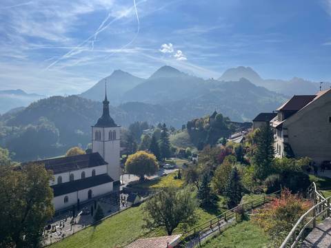 Village with hilltop church and scenic mountain views.
