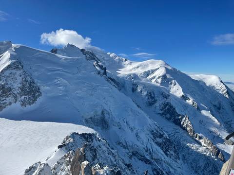 Snow-covered mountain peaks under a clear blue sky.